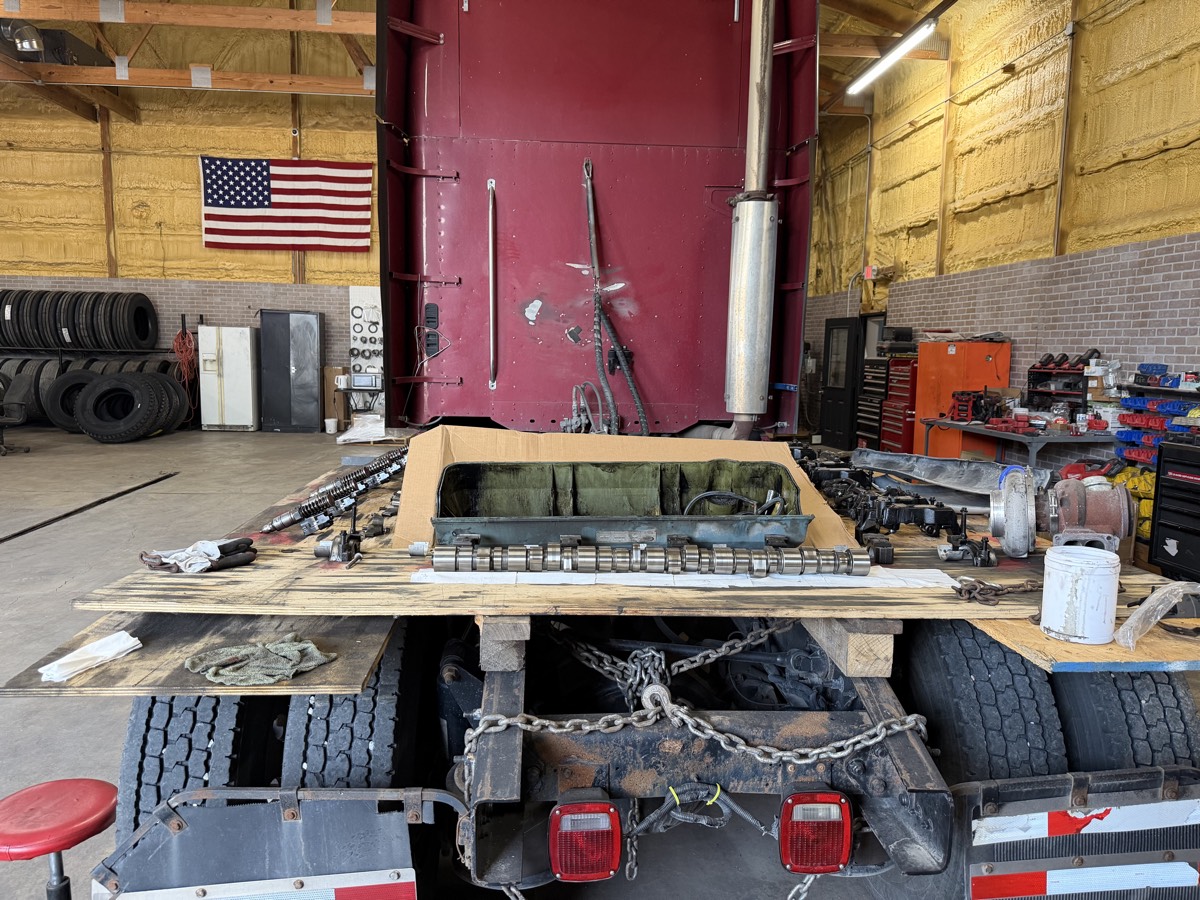 Engine and driveline parts laid out during a repair at the shop